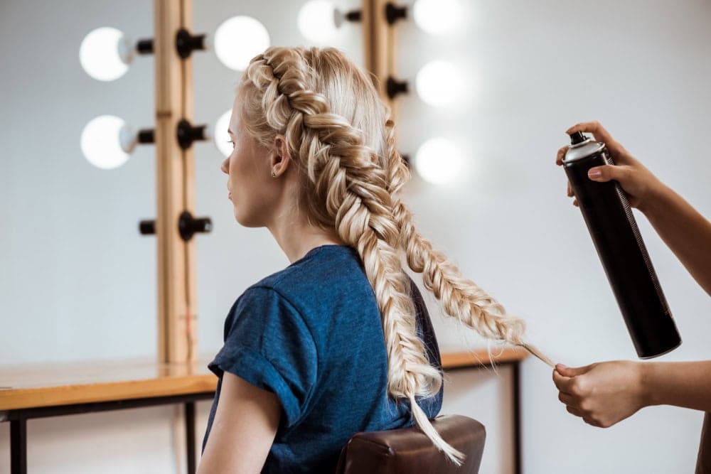 Stylist working on client's hair